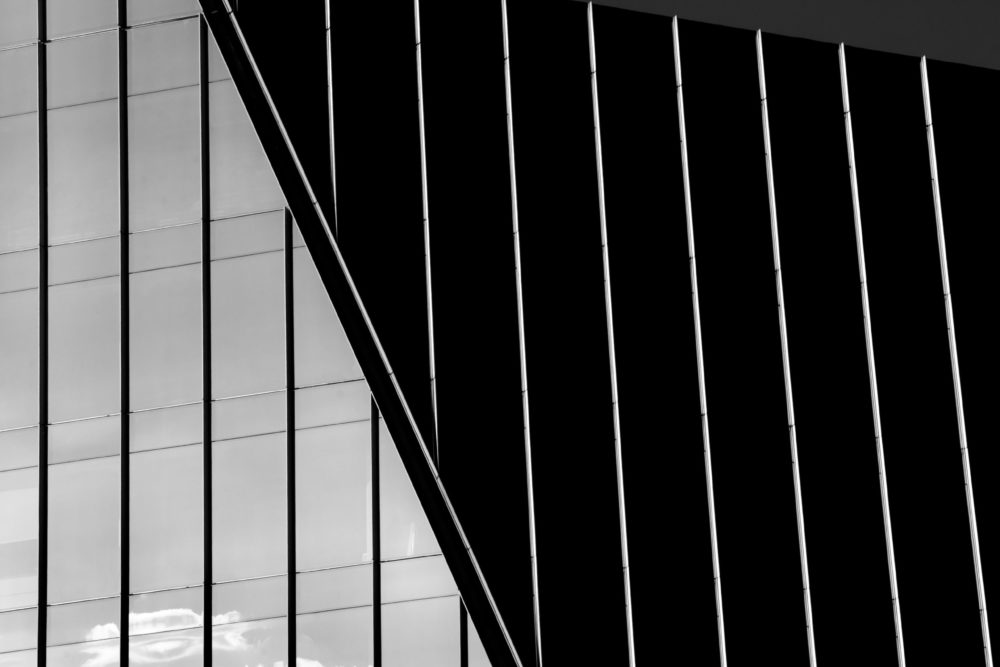 Black and white architecture building with glass and grey sky